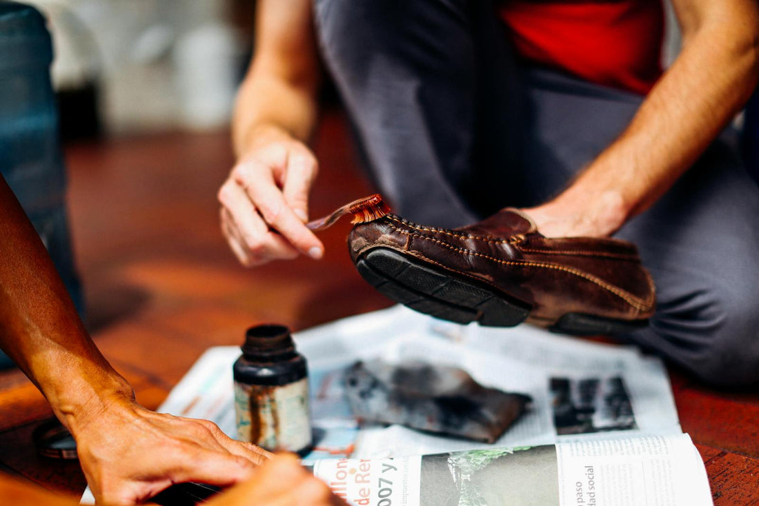Hand-applying polish to leather shoe
